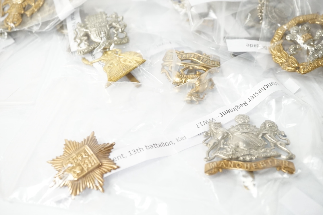 Fifty military cap badges including; the Norfolk regiment, the 16th Queen’s Lancers, Army Education Corps, Bedfordshire Yeomanry, Princess Victoria‘s Royal Irish Fusiliers, Northamptonshire Yeomanry, Royal Naval Division